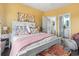 Bright bedroom with colorful decor, a white bed frame, and open access to the bathroom at 2304 Pointe Marsh Ln., North Myrtle Beach, SC 29582