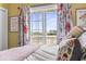 Bedroom view through glass doors that overlook a marsh and distant buildings at 2304 Pointe Marsh Ln., North Myrtle Beach, SC 29582