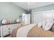 Serene bedroom with soft blue walls, dresser, comfortable bed, and bright natural light at 2304 Pointe Marsh Ln., North Myrtle Beach, SC 29582