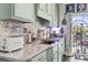 Well-appointed kitchen featuring light cabinetry, granite countertops, and modern appliances at 2304 Pointe Marsh Ln., North Myrtle Beach, SC 29582