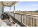 Scenic porch view overlooking a marsh with distant buildings and a light blue sky at 2304 Pointe Marsh Ln., North Myrtle Beach, SC 29582