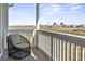 Inviting porch with marsh view and distant buildings with wicker seating at 2304 Pointe Marsh Ln., North Myrtle Beach, SC 29582