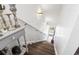 Bright staircase leading to the ground floor, featuring wood steps, white risers, and natural light at 2304 Pointe Marsh Ln., North Myrtle Beach, SC 29582