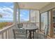 View from the balcony of the ocean, pool, and other condos and an outdoor table and chairs at 2405 S Ocean Blvd. # 105, North Myrtle Beach, SC 29582