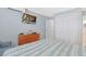 Bright bedroom featuring a spacious closet, dresser, and a mounted television for entertainment at 2405 S Ocean Blvd. # 105, North Myrtle Beach, SC 29582
