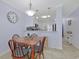 Dining area featuring a wooden table and chairs, with a kitchen in the background at 2405 S Ocean Blvd. # 105, North Myrtle Beach, SC 29582