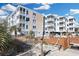Exterior view of a light blue condo building and pool with ocean views and American and South Carolina flags at 2405 S Ocean Blvd. # 105, North Myrtle Beach, SC 29582