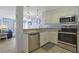 Open-concept kitchen with stainless steel appliances, granite countertops, and a seamless flow into the living area at 2405 S Ocean Blvd. # 105, North Myrtle Beach, SC 29582