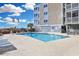 Exterior view of a sparkling in-ground community pool with ample lounge seating and ocean views at 2405 S Ocean Blvd. # 105, North Myrtle Beach, SC 29582