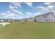 Expansive backyard with green lawn, picnic table, and pond views, perfect for outdoor enjoyment at 245 Maiden'S Choice Dr., Conway, SC 29527