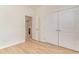 View of a bedroom with wood-style floors, showing the closet and an ensuite bathroom at 245 Maiden'S Choice Dr., Conway, SC 29527