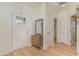 Bright entryway with light wood floors, white trim and a foyer table with a mirror at 245 Maiden'S Choice Dr., Conway, SC 29527