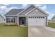 Two-car garage and well-maintained front yard, offering convenience and beauty at 245 Maiden'S Choice Dr., Conway, SC 29527