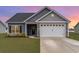 Charming single-story home with gray siding, a two-car garage, and a well-maintained lawn at 245 Maiden'S Choice Dr., Conway, SC 29527