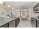 Well-lit kitchen with granite counters, dark cabinets, and open view to the dining area at 245 Maiden'S Choice Dr., Conway, SC 29527