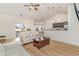 Inviting living room with light-colored sofas, a ceiling fan, and an open view to the kitchen at 245 Maiden'S Choice Dr., Conway, SC 29527