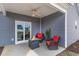 Covered patio with ceiling fan, red chairs and a fire pit for enjoying the outdoors at 245 Maiden'S Choice Dr., Conway, SC 29527