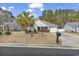 Charming single-story home with a well-maintained front yard, palm tree, and an attached garage at 248 Upper Saddle Circle, Conway, SC 29526