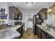 Kitchen featuring dark cabinetry, stainless appliances, and a view into the laundry area at 248 Upper Saddle Circle, Conway, SC 29526