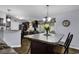 Kitchen island with dark cabinets and decorative lighting at 248 Upper Saddle Circle, Conway, SC 29526