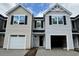 Charming townhouse exterior with light siding, black shutters, and attached one-car garages under a blue sky at 262 Christiana Ln. # B, Myrtle Beach, SC 29579