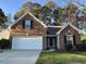 Charming brick home featuring an attached garage and well-maintained lawn at 280 Barclay Dr., Myrtle Beach, SC 29579