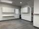 Spacious garage with white cabinets, work bench, and door to exterior, perfect for storage and projects at 280 Barclay Dr., Myrtle Beach, SC 29579