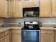 Modern kitchen with stainless steel appliances, including oven and microwave, with light wood cabinetry at 280 Barclay Dr., Myrtle Beach, SC 29579