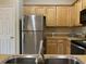 Spacious kitchen with stainless steel refrigerator and light wood cabinetry provides modern convenience at 280 Barclay Dr., Myrtle Beach, SC 29579