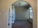 Bright living room featuring an arched doorway and french doors leading to a sunroom at 280 Barclay Dr., Myrtle Beach, SC 29579