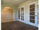 Cozy living area with french doors and neutral carpeting offers a welcoming atmosphere at 280 Barclay Dr., Myrtle Beach, SC 29579