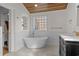 Bright bathroom featuring a soaking tub, wood ceilings and white brick wall at 288 Rum Gully Rd., Murrells Inlet, SC 29576