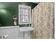 Traditional bathroom with white pedestal sink, patterned shower curtain, and decorative towel at 288 Rum Gully Rd., Murrells Inlet, SC 29576