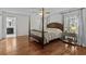 Serene main bedroom featuring a four-poster bed, hardwood floors, and a neutral color palette at 288 Rum Gully Rd., Murrells Inlet, SC 29576