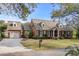Beautiful brick home with attached garage, well-maintained landscaping, and classic architectural details at 288 Rum Gully Rd., Murrells Inlet, SC 29576
