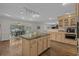 Open-concept kitchen with an island, sink, and views to the breakfast room and other living spaces at 288 Rum Gully Rd., Murrells Inlet, SC 29576