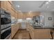 Bright kitchen featuring modern appliances, custom cabinetry, and an island with seating and sink at 288 Rum Gully Rd., Murrells Inlet, SC 29576