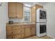 Laundry room with sink, counter, and stacked washer and dryer at 288 Rum Gully Rd., Murrells Inlet, SC 29576