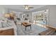 Open-concept living room with hardwood floors and seamless flow to sunroom at 288 Rum Gully Rd., Murrells Inlet, SC 29576