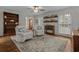 Comfortable living area with armchairs, hardwood floors, and built-in bar shelves at 288 Rum Gully Rd., Murrells Inlet, SC 29576