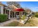 Cozy outdoor patio with brick detail, grill, dining set, and lush backyard at 288 Rum Gully Rd., Murrells Inlet, SC 29576