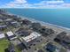 Aerial view showcases this condo building near the beach, with a fantastic location, and the ocean nearby at 301 N Waccamaw Dr. # 209, Garden City Beach, SC 29576