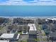 An aerial shot displays the condo building's proximity to the beach, surrounded by neighboring homes at 301 N Waccamaw Dr. # 209, Garden City Beach, SC 29576