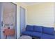 Balcony features a blue outdoor sofa and chairs, offering an outdoor relaxation area adjacent to the living room at 301 N Waccamaw Dr. # 209, Garden City Beach, SC 29576