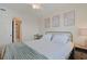 Bright bedroom with comfortable bed, ceiling fan, neutral colors and beach themed wall art at 301 N Waccamaw Dr. # 209, Garden City Beach, SC 29576