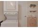 Practical laundry area featuring a stackable washer and dryer, with additional storage and shelving at 301 N Waccamaw Dr. # 209, Garden City Beach, SC 29576
