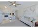 Living room space featuring a sofa, a display case and a partial view of the kitchen with white appliances and soft decor at 301 N Waccamaw Dr. # 209, Garden City Beach, SC 29576