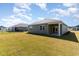 Spacious backyard with green grass, partially covered patio and plenty of room for outdoor activities at 303 Clear Lake Dr., Conway, SC 29526