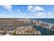 Aerial view of a coastal neighborhood featuring waterfront homes, a channel, and an ocean view, all under a bright, partly cloudy sky at 310 37Th Ave. N, North Myrtle Beach, SC 29582