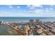 A high-angle view highlights oceanfront condos and homes nestled along a waterway under a bright, partly cloudy sky at 310 37Th Ave. N, North Myrtle Beach, SC 29582
